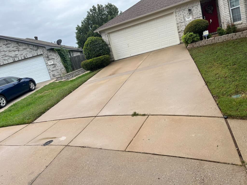 Clean residential concrete driveway after professional pressure washing